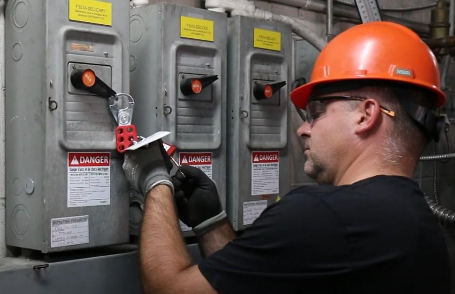 Lockout/Tagout (LOTO): Essential Electrical Safety Procedures for Industrial Facilities Technician performing Lockout/Tagout procedure on industrial electrical equipment.